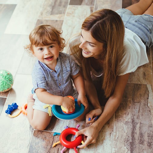 Mom playing with baby | Affordable Flooring Warehouse